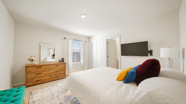 bedroom featuring light colored carpet