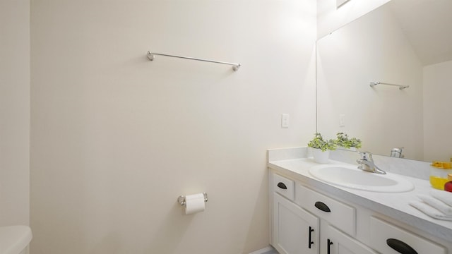 bathroom with toilet and vanity