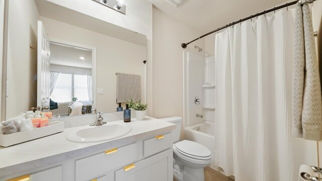 full bathroom featuring toilet, shower / tub combo, and vanity