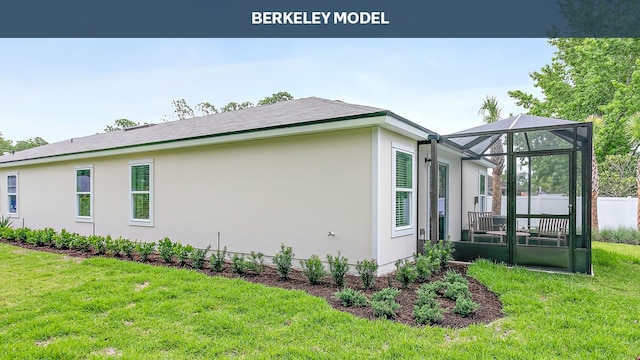 view of side of property featuring a lawn and glass enclosure