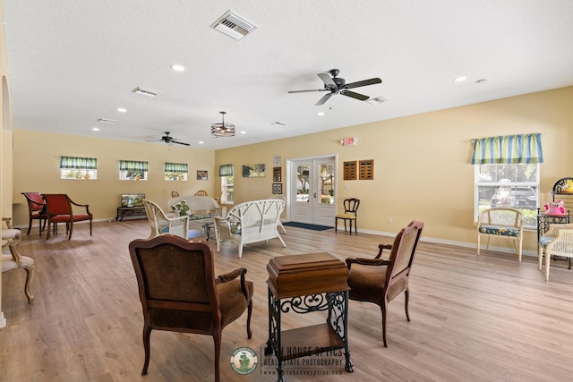 living room with light wood-style floors, ceiling fan, recessed lighting, and visible vents