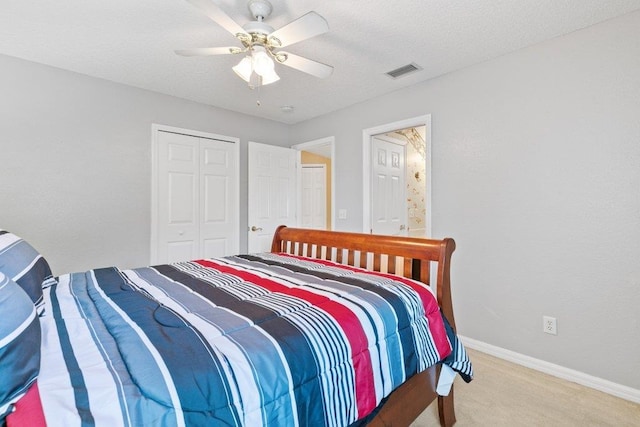 bedroom with visible vents, a ceiling fan, a closet, baseboards, and carpet flooring