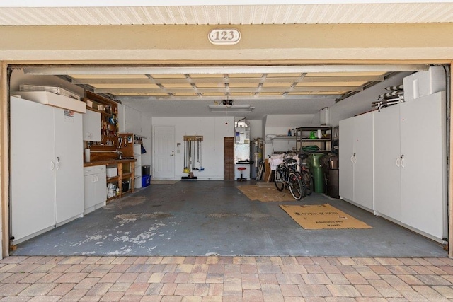 garage with a garage door opener and water heater
