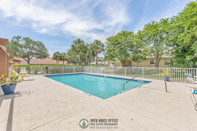 community pool featuring a patio and fence