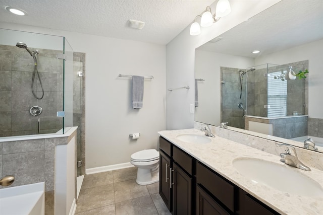 1337 Nochaway Dr, Saint Augustine, FL 32092 - bathroom with a stall shower, double vanity, a garden tub, toilet, and a textured ceiling
