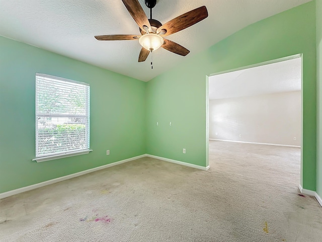 spare room with carpet, ceiling fan, and a textured ceiling