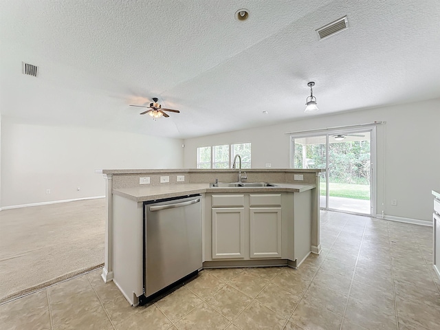 kitchen featuring stainless steel dishwasher, pendant lighting, sink, and a kitchen island with sink