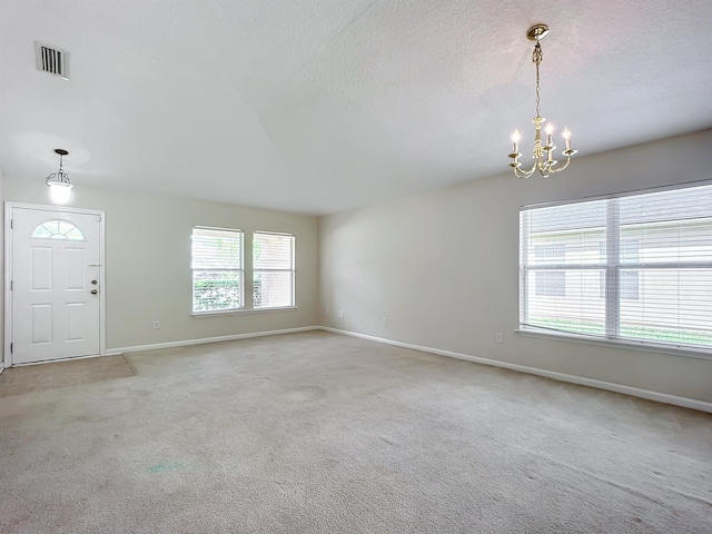 interior space featuring a notable chandelier and light colored carpet