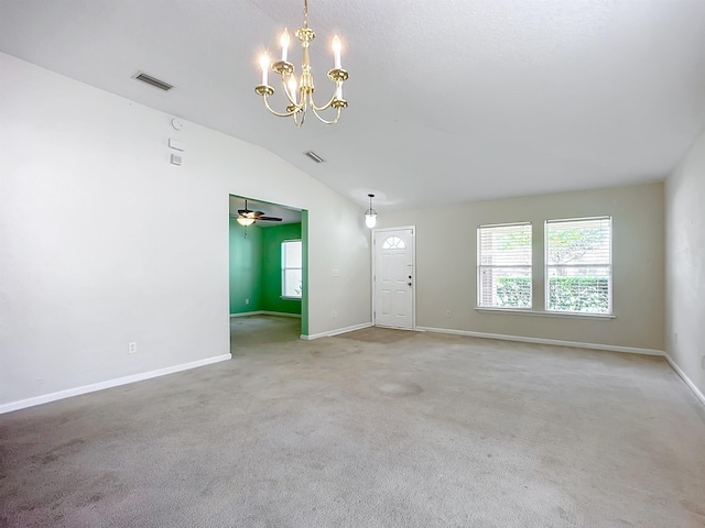 interior space with ceiling fan with notable chandelier and vaulted ceiling