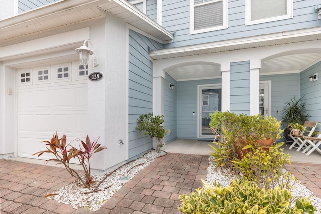 entrance to property with a garage and a porch