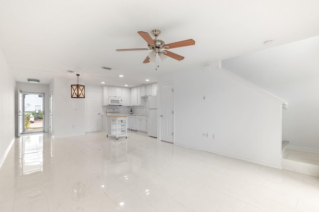 unfurnished living room featuring ceiling fan