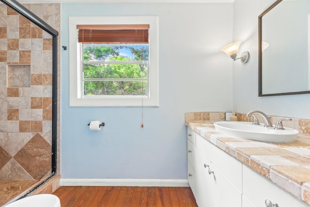 26 Ponce De Leon Ave, Saint Augustine, FL 32080 - bathroom with vanity, a stall shower, and wood finished floors