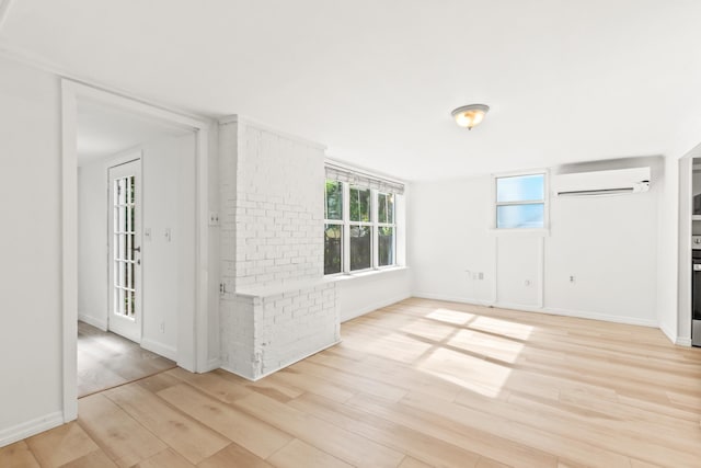 26 Ponce De Leon Ave, Saint Augustine, FL 32080 - empty room with an AC wall unit and light wood-type flooring