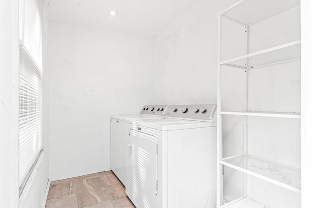 26 Ponce De Leon Ave, Saint Augustine, FL 32080 - washroom featuring washer and clothes dryer, attic access, and light stone finish floors