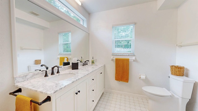 23 Fancher Ct, Saint Augustine, FL 32080 - bathroom with tile patterned floors, toilet, double vanity, and baseboards