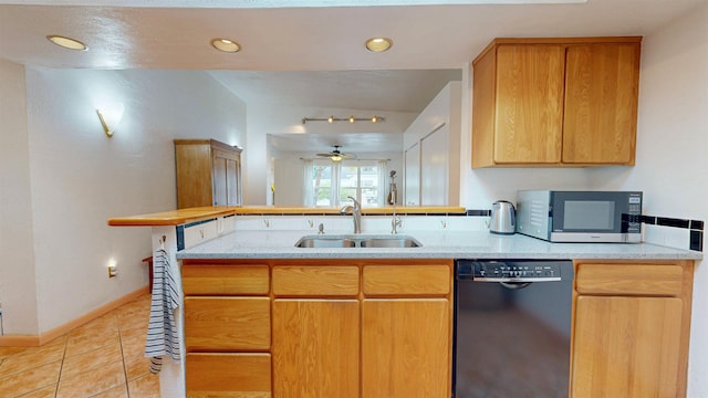 23 Fancher Ct, Saint Augustine, FL 32080 - kitchen with black dishwasher, stainless steel microwave, a sink, ceiling fan, and light stone counters