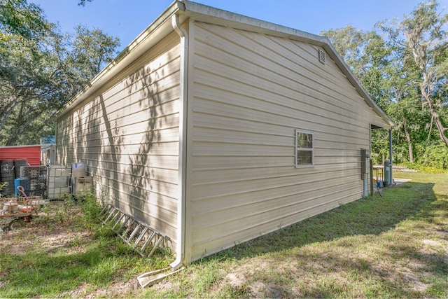 view of side of home with a lawn