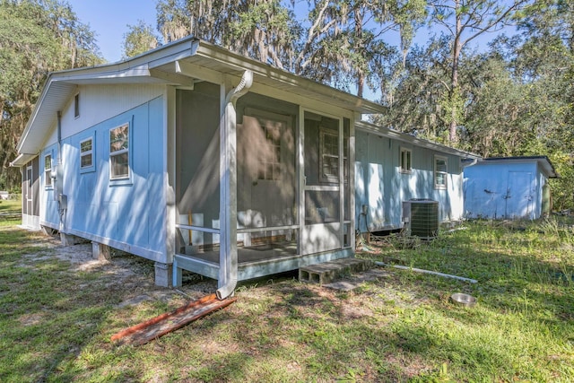 view of side of home featuring central AC