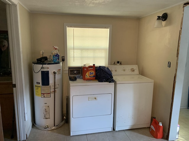 laundry room with light tile patterned floors, washing machine and dryer, and electric water heater