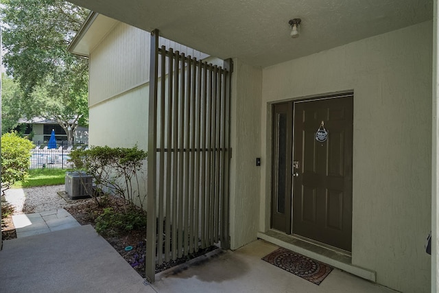 doorway to property featuring central air condition unit