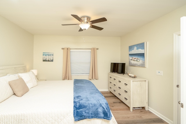 bedroom featuring ceiling fan and light hardwood / wood-style flooring