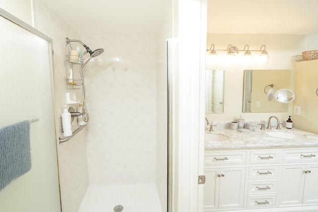 bathroom with walk in shower and vanity