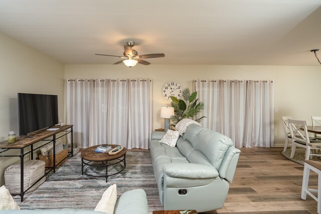 living room with hardwood / wood-style flooring and ceiling fan