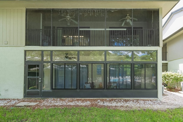 doorway to property featuring ceiling fan