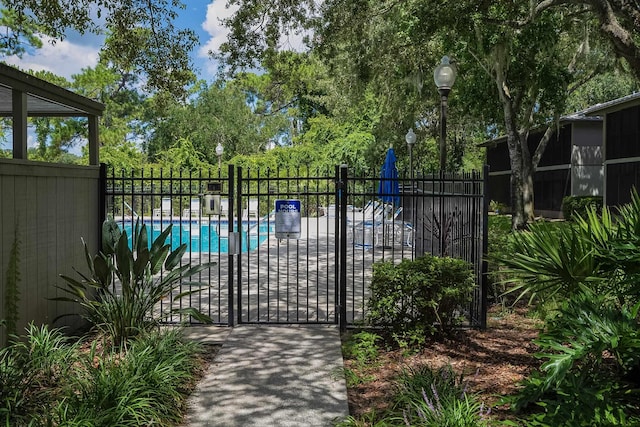 view of gate featuring a community pool