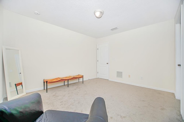 sitting room featuring light carpet