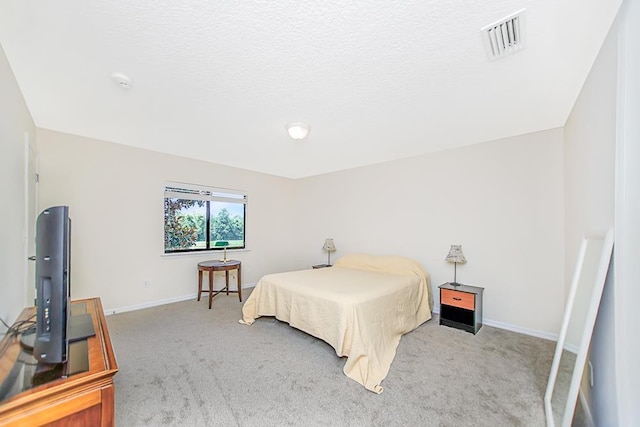 carpeted bedroom with a textured ceiling
