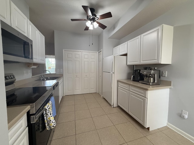1804 Prestwick Pl Unit 1804, Saint Augustine, FL 32086 - kitchen with a ceiling fan, range with electric cooktop, a sink, stainless steel microwave, and light tile patterned flooring