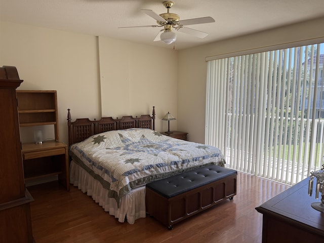 bedroom with access to exterior, ceiling fan, and dark hardwood / wood-style flooring