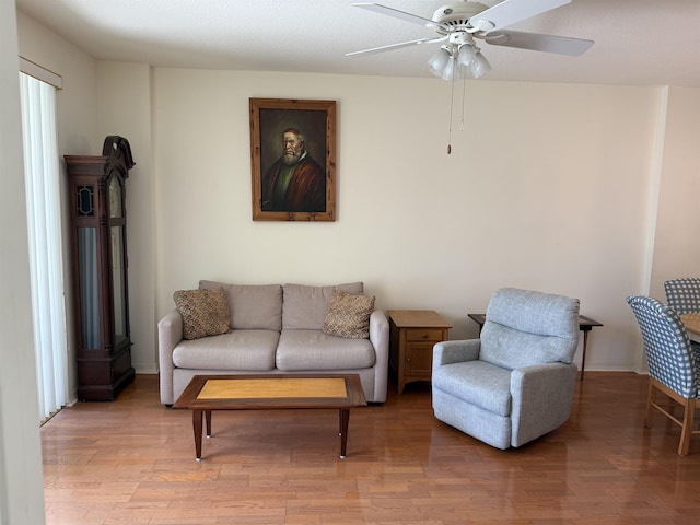 sitting room featuring ceiling fan, light hardwood / wood-style floors, and a textured ceiling