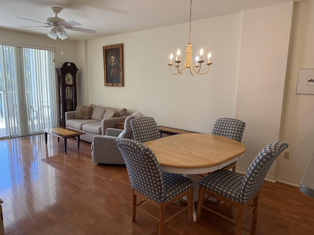 dining space featuring ceiling fan with notable chandelier and dark hardwood / wood-style flooring