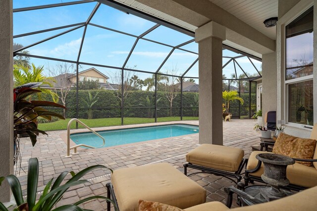 pool at dusk featuring a lanai, ceiling fan, and a patio area