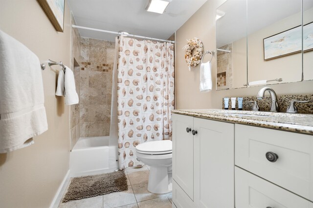 full bathroom featuring tile patterned flooring, vanity, toilet, and shower / bath combo