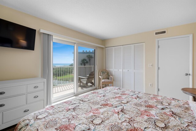 bedroom featuring access to exterior and a closet