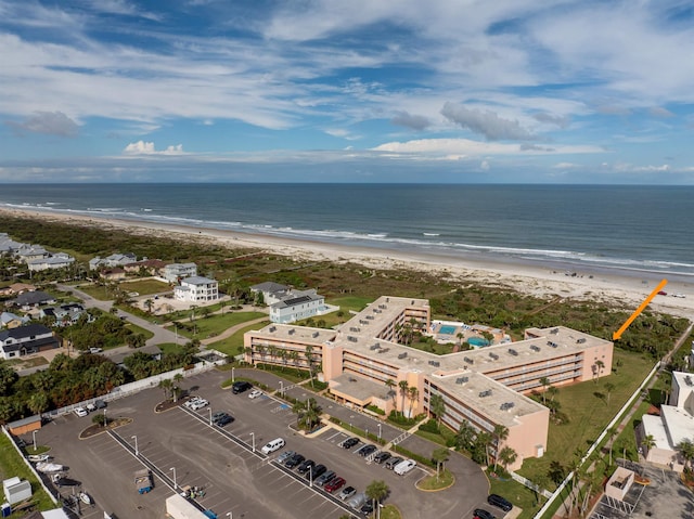 birds eye view of property featuring a view of the beach and a water view