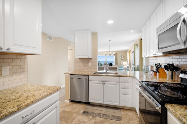 kitchen with decorative backsplash, sink, white cabinets, and appliances with stainless steel finishes