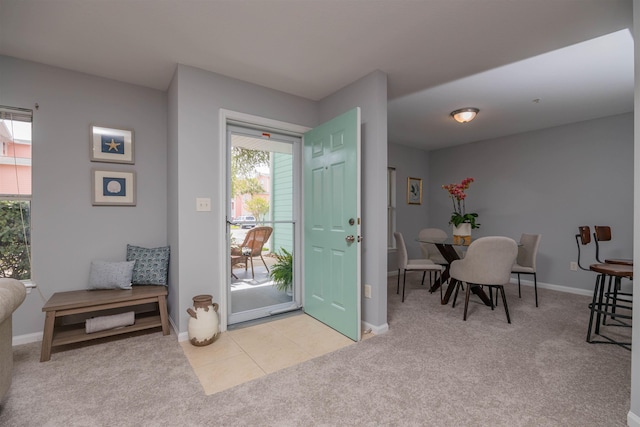 foyer entrance featuring light carpet