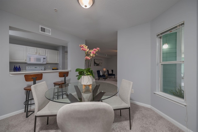 view of carpeted dining space