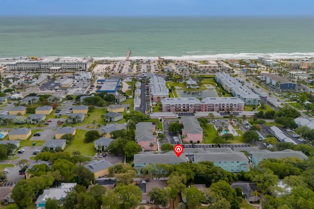 drone / aerial view featuring a beach view and a water view