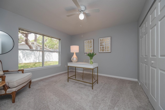 carpeted office with ceiling fan