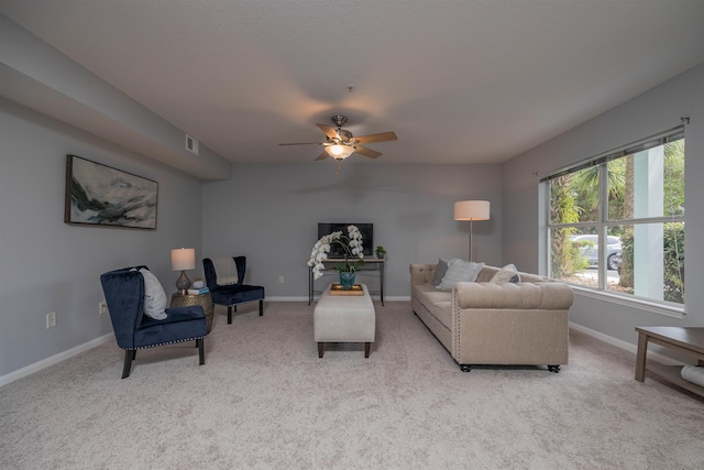 living room with ceiling fan and light colored carpet