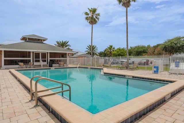 view of pool with a patio area and a sunroom