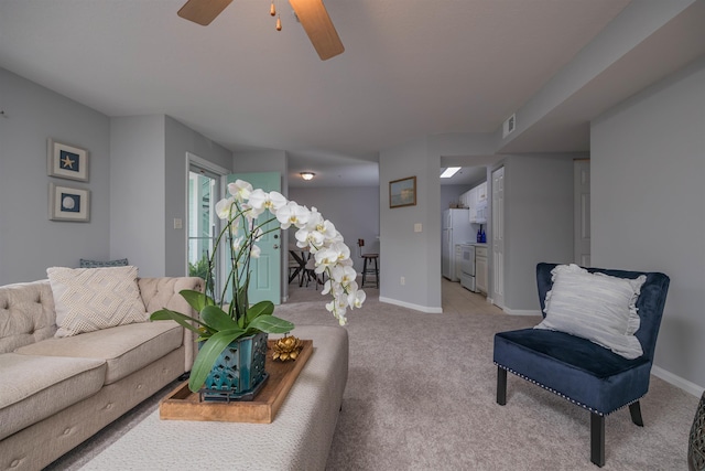 living room featuring light carpet and ceiling fan