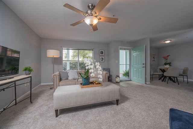 carpeted living room featuring ceiling fan