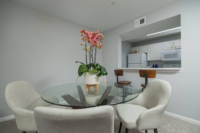 view of carpeted dining space