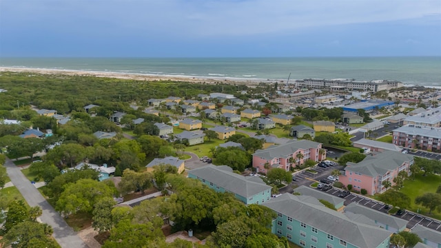 birds eye view of property featuring a water view and a beach view